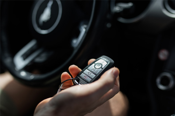person holding a key fob in a car